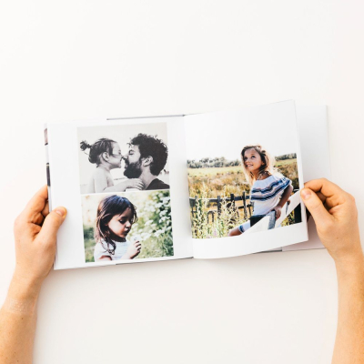 Custom hardcover photo book open with family photo layouts