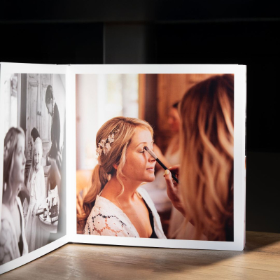 Signature Layflat Wedding Album on a table, the book is 10 x 10 inches.