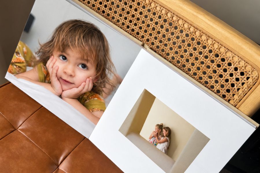 Inkifi linen layflat photo book open on a chair, printed in the UK