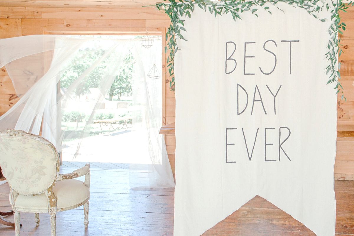 Wedding ceremony space with sign reading Best Day Ever: wedding photo book wording ideas