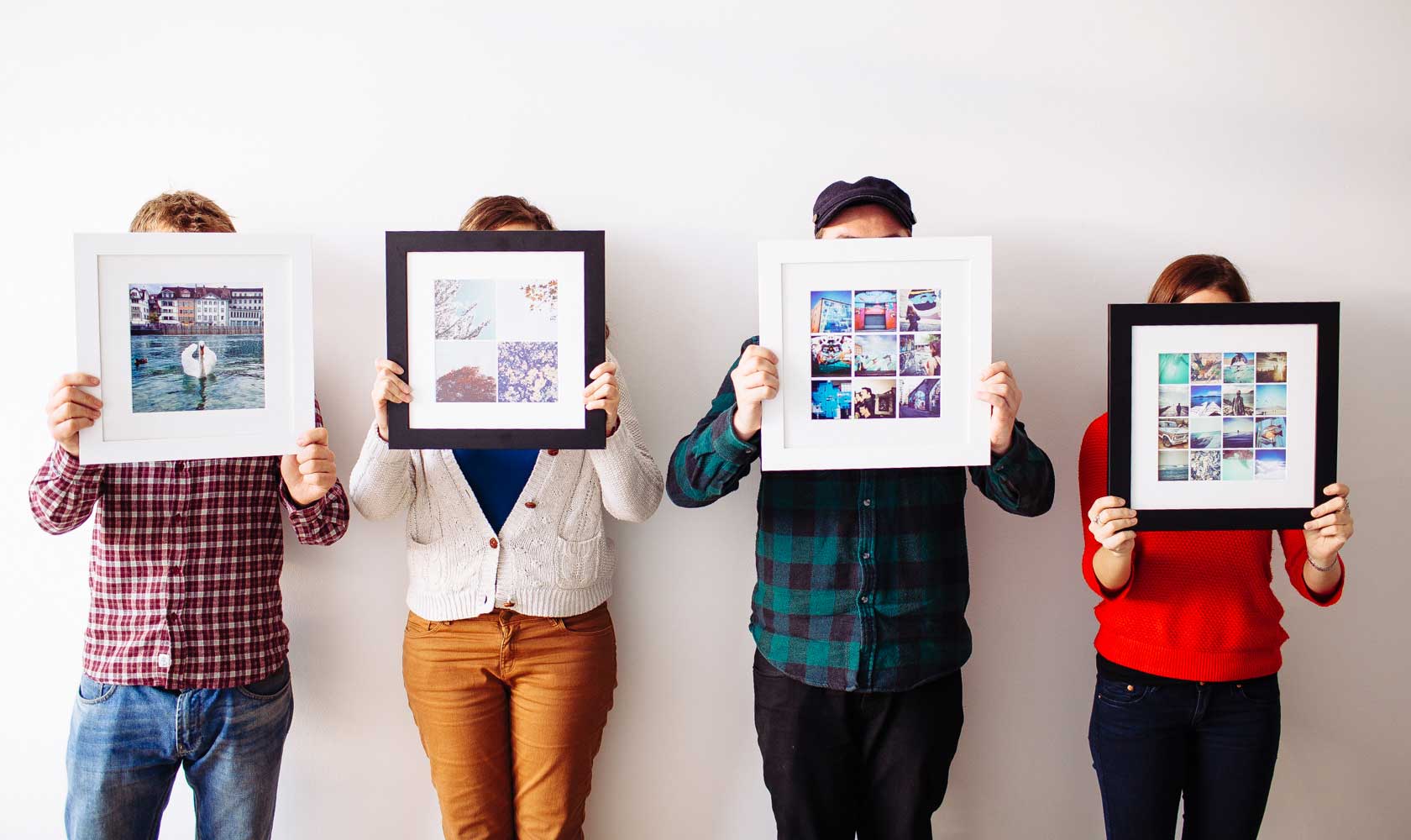 people holding up framed wall art