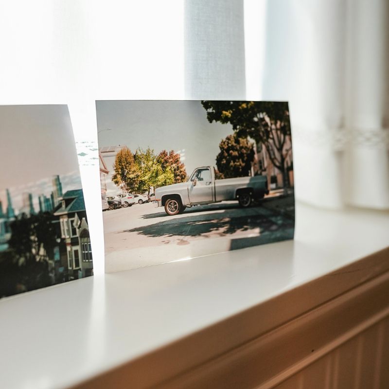 Premium photo prints on a window ledge, printed on Fuji photo paper