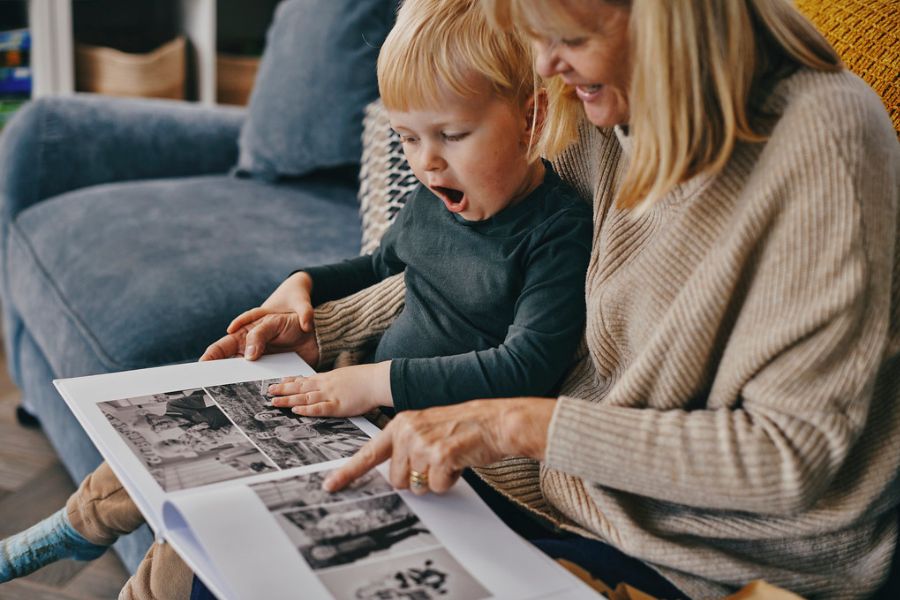 Open photo book showing holiday photos arranged across a double page spread
