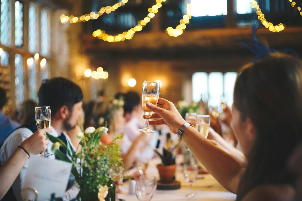 People raising glasses at wedding: wedding album ideas