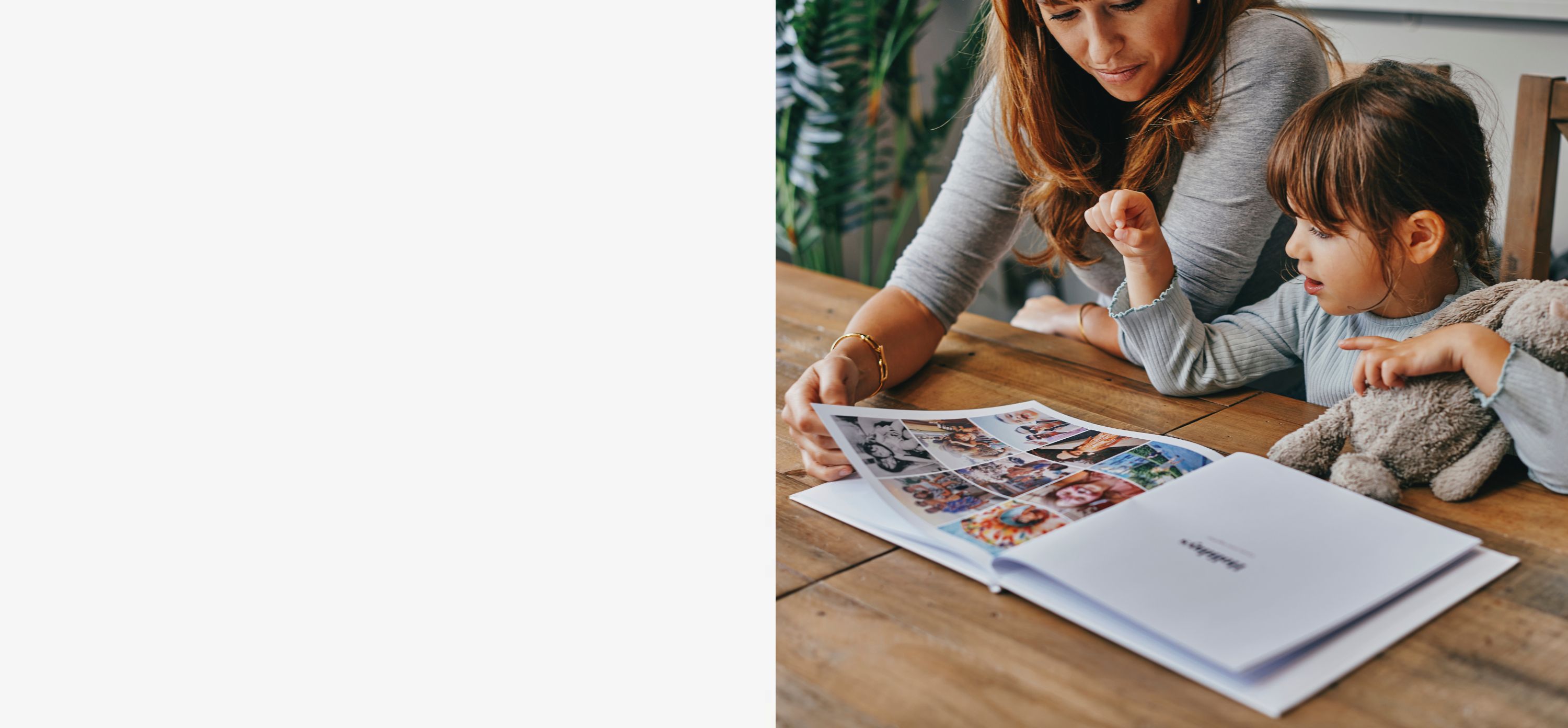 Mother and daughter looking through a personalised photo book together – photo books Australia