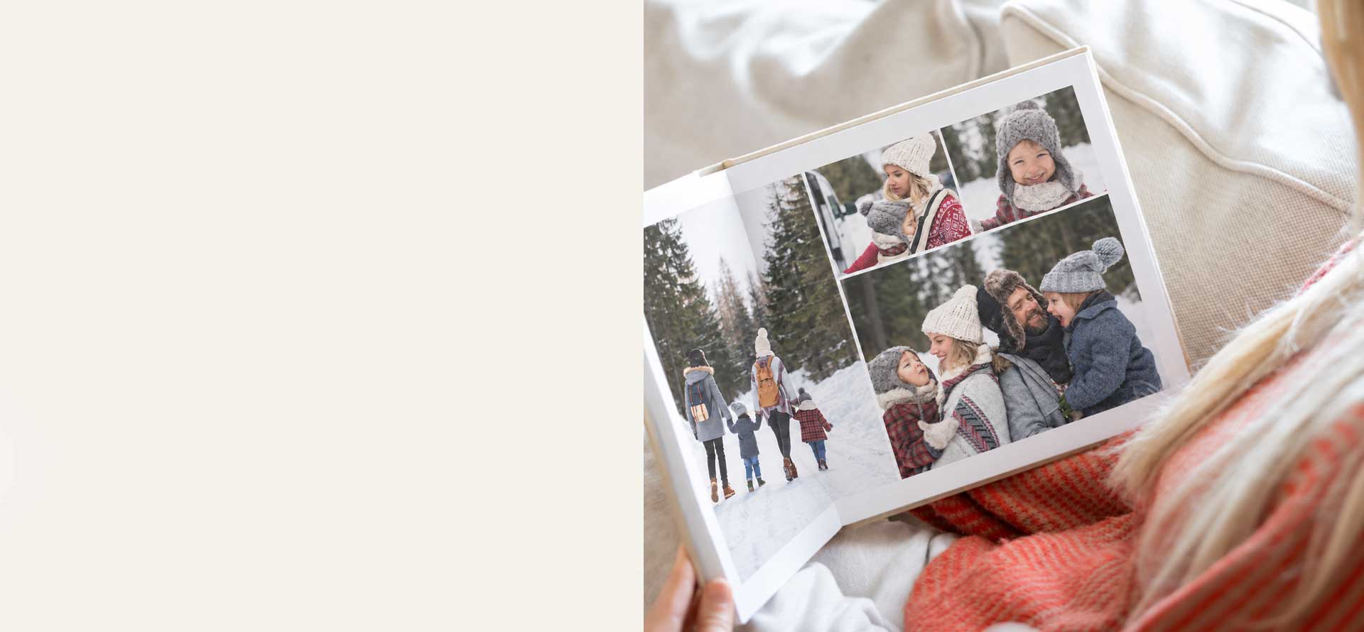 Woman browsing a personalised photo book filled with family memories from a snowy winter holiday