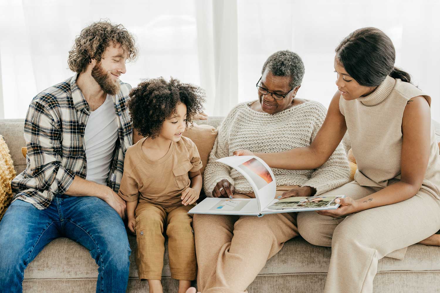 Family looking through a custom hardcover photo book at home