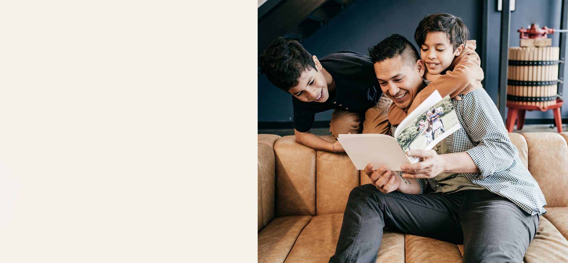 Father and sons looking at a beautiful photo book