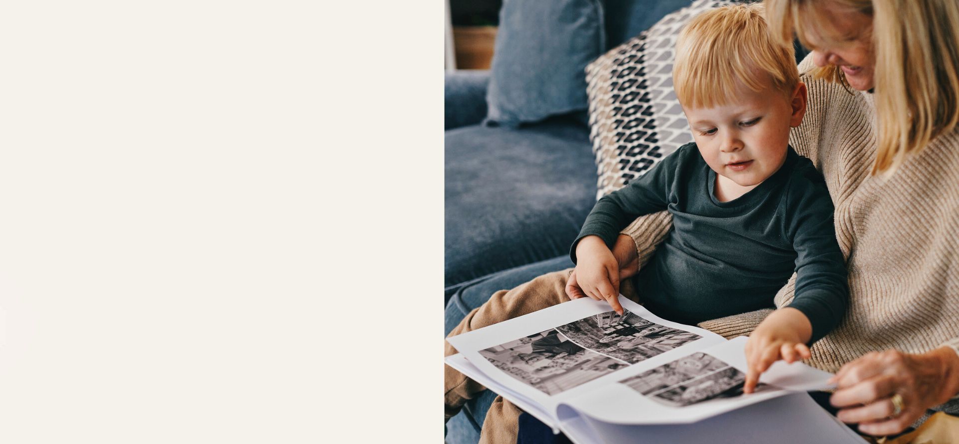 Grandmother and grandson looking through a personalised Mother's Day photo book.
