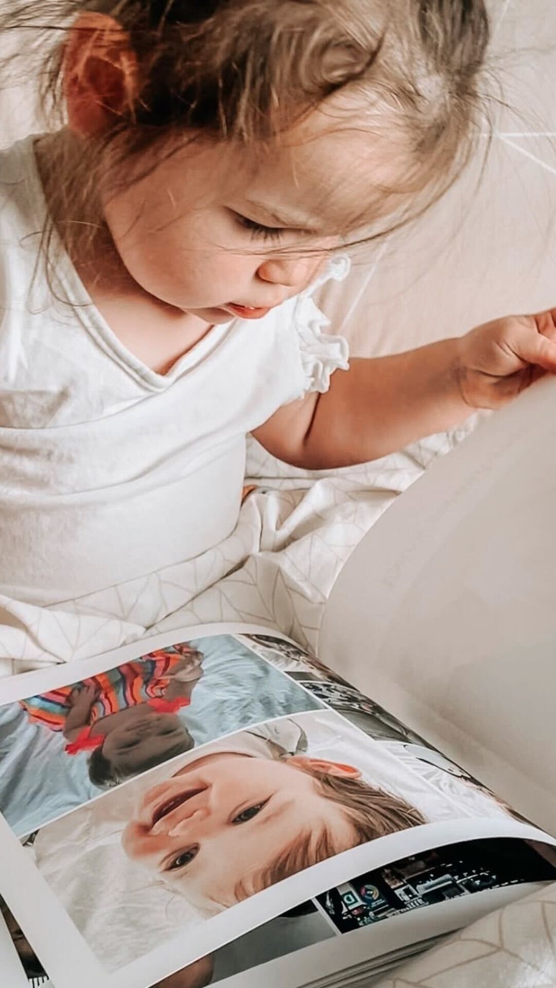 Softcover baby photo book capturing everyday family moments