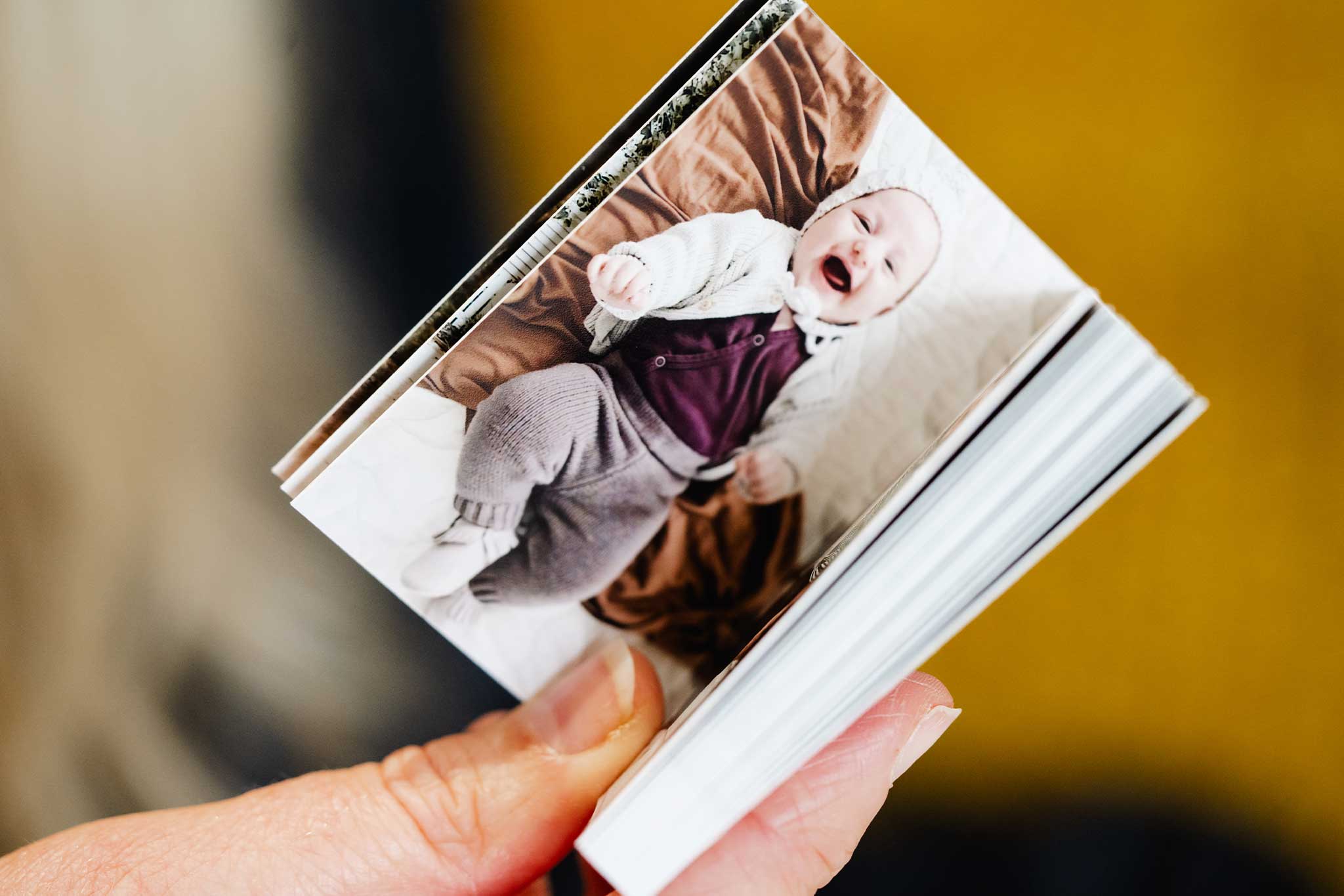 Close up of the Mini Photo Book In Hands